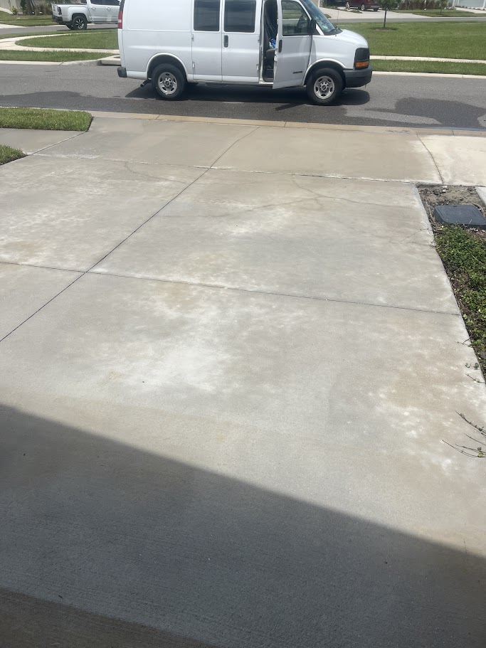 Van parked at the end of a clean driveway.
